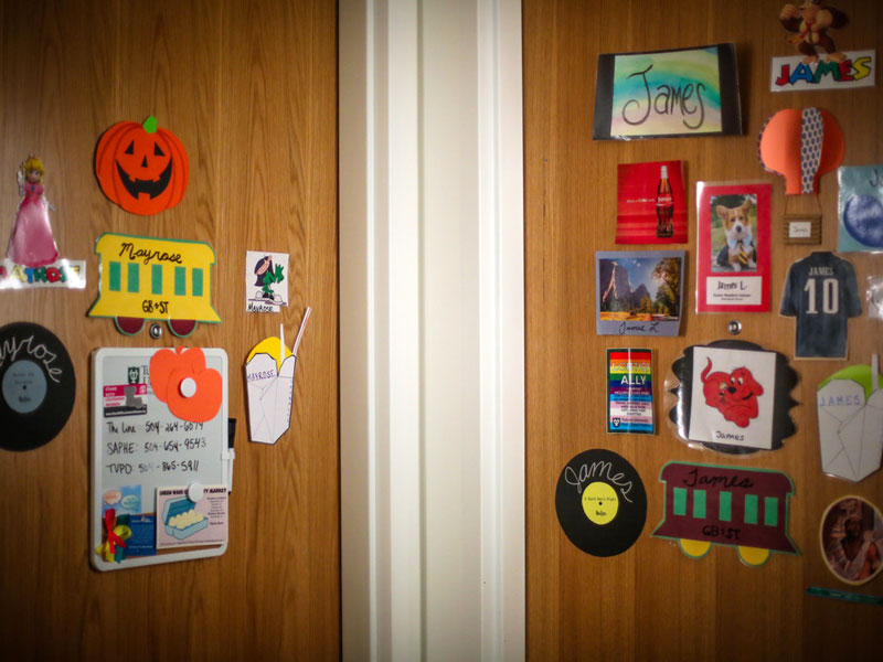 Two dorm room doors decorated with decals and stickers