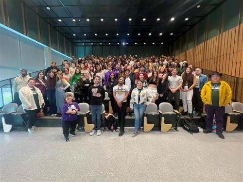 The entire residence life staff standing in the village auditorium