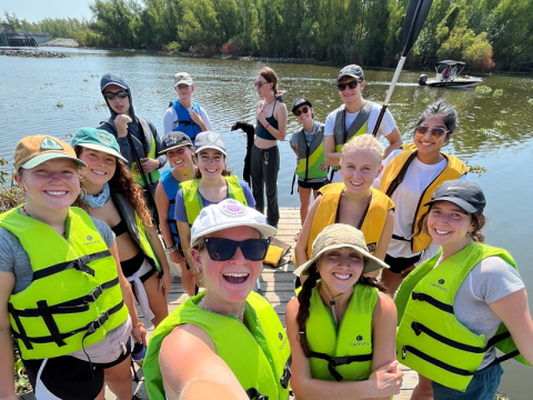 A group of students on a dock going kayaking.