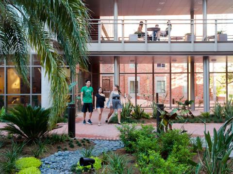 Students walk outside of their residence hall