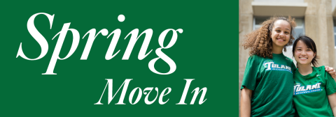 two students smiling with matching green tulane shirts