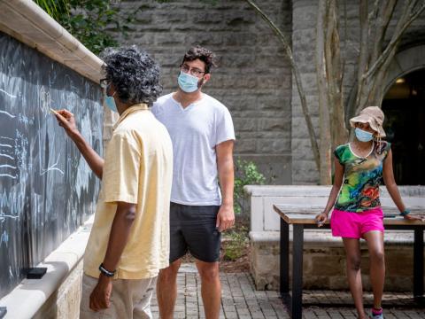 A professor teaches his class outside in Pierson Patio