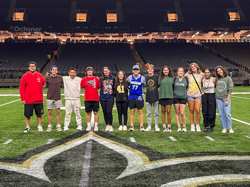 Tulane students on Saints field at Ceasars Superdome